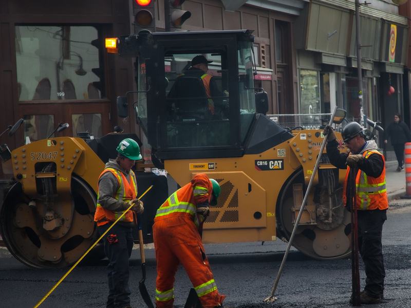 Asphalt paving and sealcoating crew working near Cedar Rapids